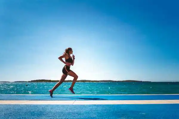 Woman running showing strong leg muscle Walton on the Hill